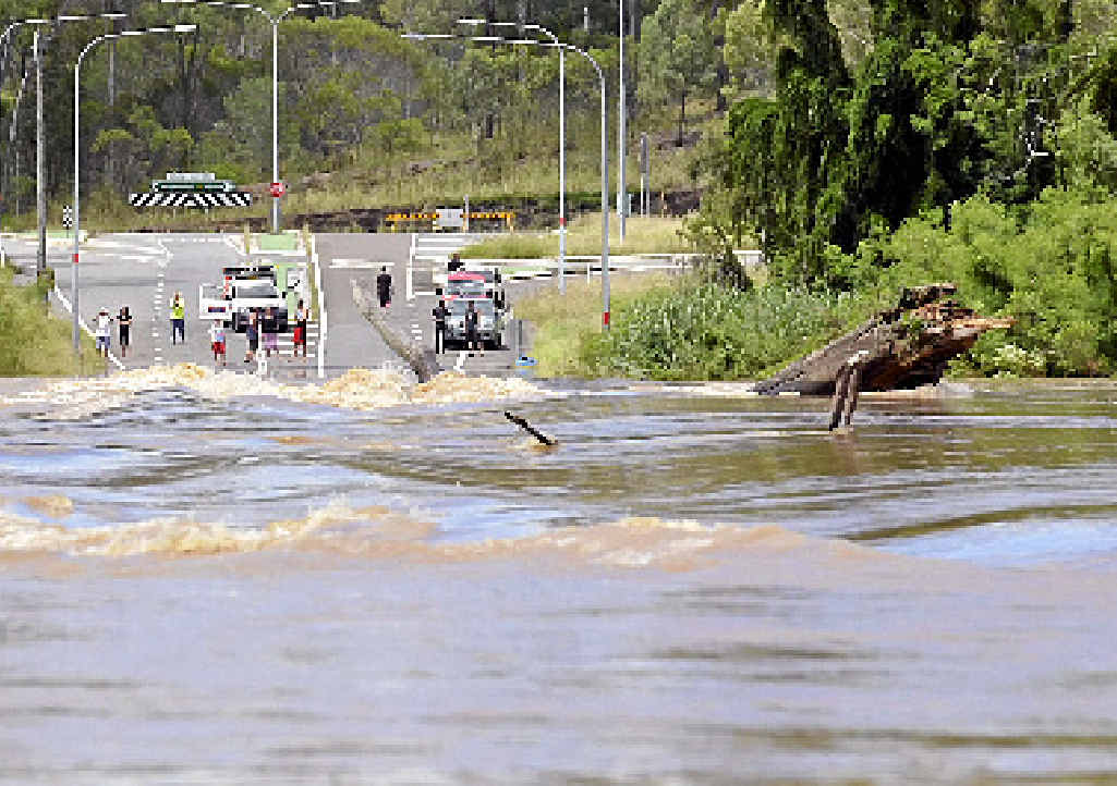 ABOVE: Cody Whiteman, of Fortrus Pastoral on the Wide Bay Hwy, took this photo of a massive tree that smashed into the deck of Bells Bridge on Saturday. RIGHT: The tree remained wedged in the decking as the floodwater receded. ABOVE: Cody Whiteman, of Fortrus Pastoral on the Wide Bay Hwy, took this photo of a massive tree that smashed into the deck of Bells Bridge on Saturday. RIGHT: The tree remained wedged in the decking as the floodwater receded.